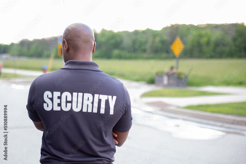 Naklejka premium Security guard in uniform patrolling inside condo apartment