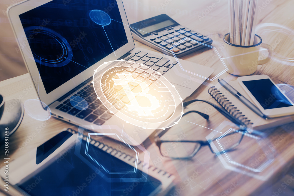 Double exposure of blockchain and crypto economy theme hologram and table with computer background. Concept of bitcoin cryptocurrency.