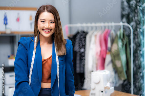 Attractive beautiful young woman standing confident with clothing business and feeling happy.