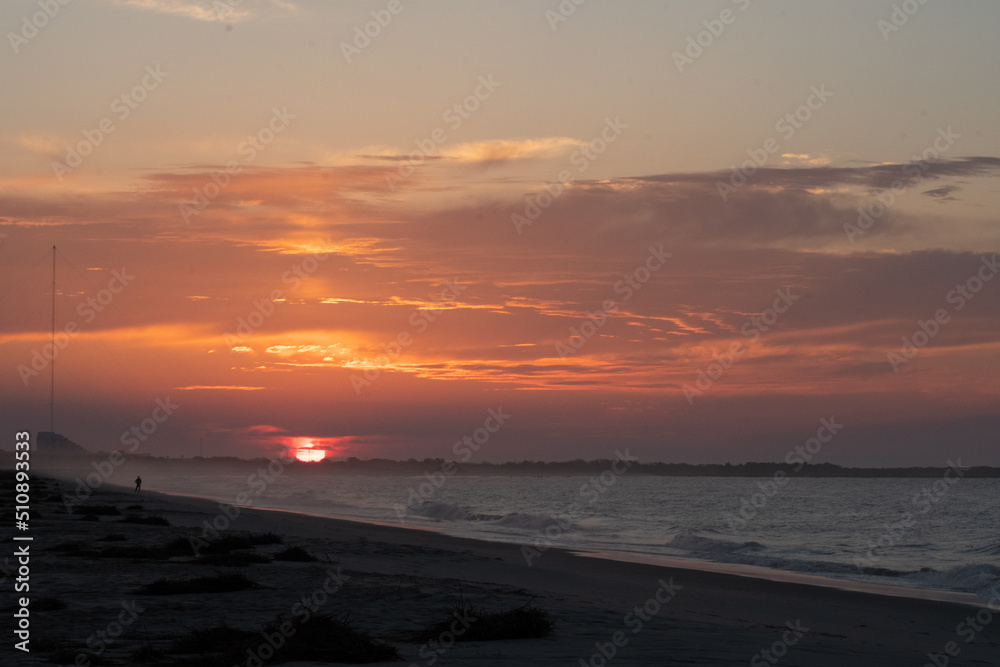 The Sun rises over the Cape May National Wildlife refuge as seen from the beach in cape may New Jersey