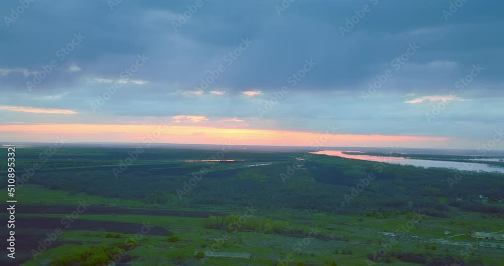 beautiful sunrise or sunset above green fields and river, aerial view over woodland, 4K, Prores beautiful sunrise or sunset above green fields and river, aerial view over woodland, 4K, Prores