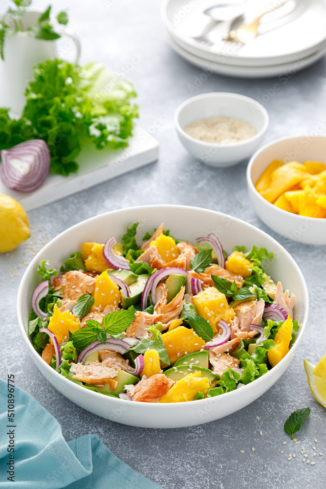 Grilled salmon and mango salad with avocado and fresh green lettuce Grilled salmon and mango salad with avocado and fresh green lettuce