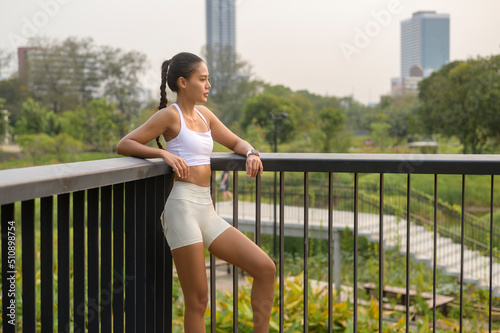 Portrait of young fitness woman in sportswear in city park  Healthy and Lifestyles.