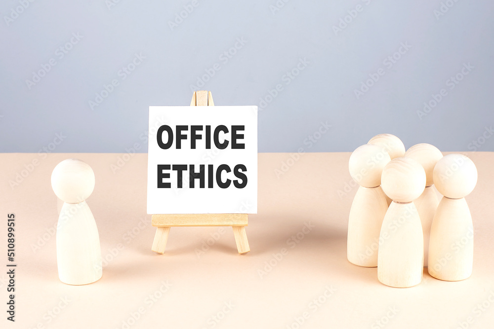 OFFICE ETHICS text on easel with wooden figure, meeting concept OFFICE ETHICS text on easel with wooden figure, meeting concept
