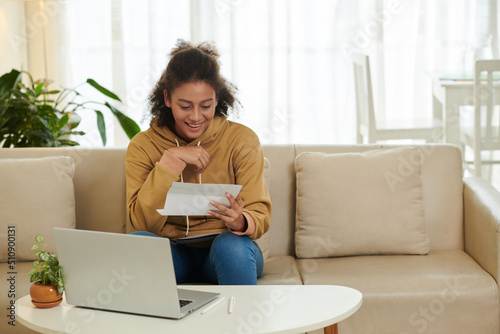 Photography Happy excited teenage girl opening acceptance letter from university she wished