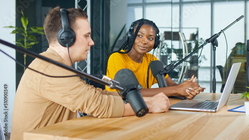 A Male Presenter Communicates with a Guest, an African American, During a Radio Broadcast at a Table in a Recording Studio, Broadcasts a Live Radio Interview With Spbd. photo