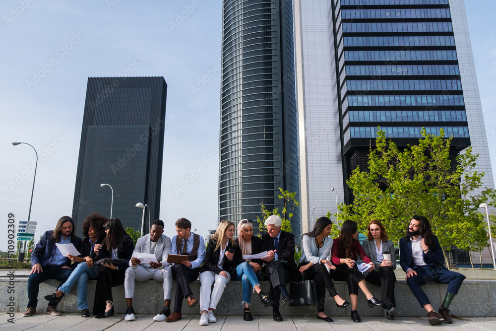 Group of workers meeting outdoors to brainstorm in financial district