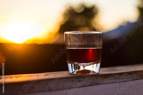 glass of whiskey at sunset