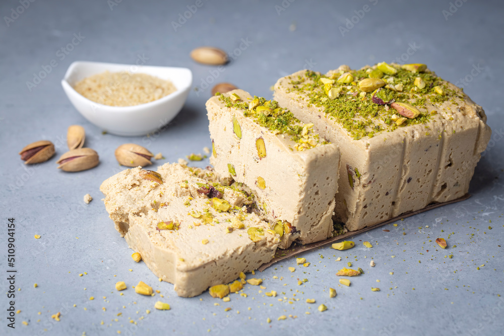 Sesame halva with pistachios on grey background. Top view. Copy space. Traditional middle