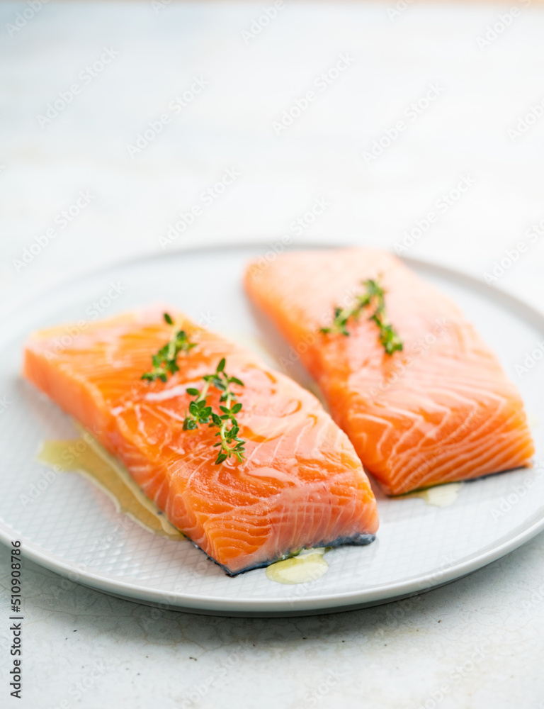 Fresh salmon fillet with herbs on a plate for delicious salmon steak.