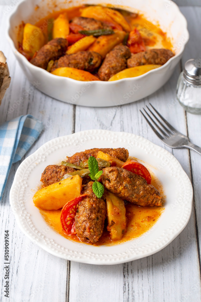 Traditional Homemade Turkish Food Kofte - Kofta with Tomato Sauce and Potatoes. (Turkish name; Izmir kofte) Traditional Homemade Turkish Food Kofte - Kofta with Tomato Sauce and Potatoes. (Turkish name; Izmir kofte)