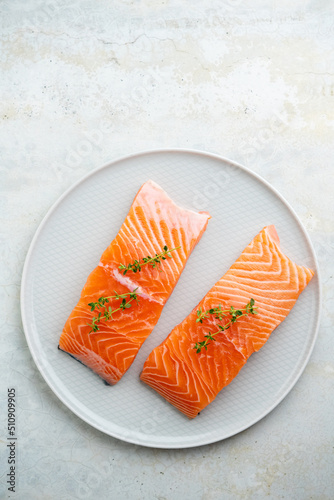 Fresh salmon fillet with herbs on a plate for delicious salmon steak.