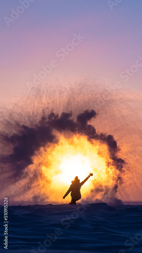 Beautiful arctic sunrise in northern Canada during peak wintertime. Woman silhouette standing in front of bright, blazing sun.  © Scalia Media