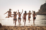 group of girls run at the beach