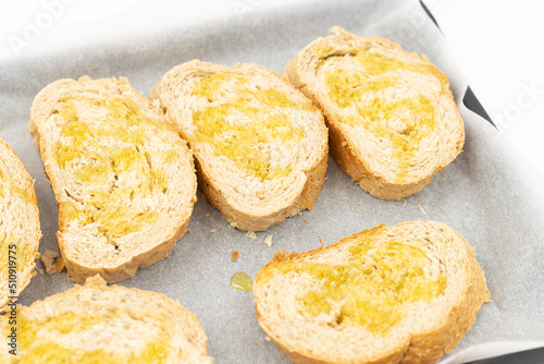 Baked bread with olive oil on the baking pan