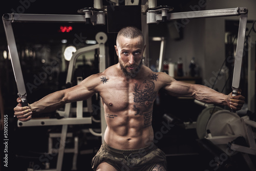 Man Doing Training On Machine For His Chest Muscle At The Gym