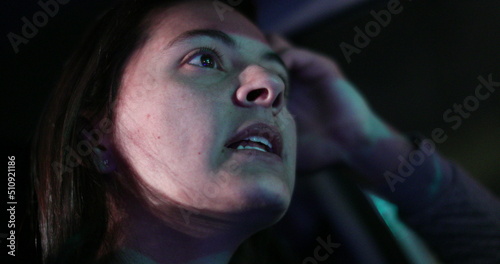 Woman driver face at night in city