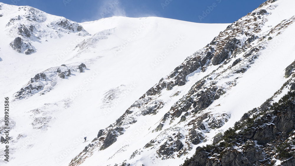 Ski alpinist climbing the snowy mountain, Slovakia, Europe