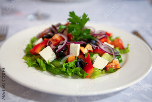 Greek salad in a white plate. Healthy food. Mediterranean Kitchen.