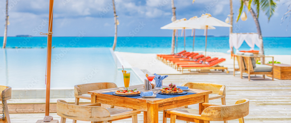 Luxury resort hotel poolside, outdoor restaurant on beach, ocean and