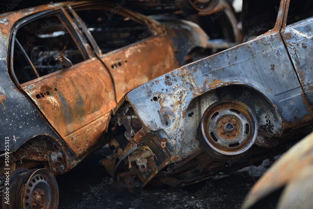 stack burnt out cars in close-up