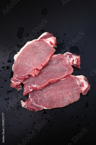 Raw meat beef steak on dark background top view.