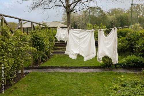 1940's underwear drying on a washing line in a cottage garden