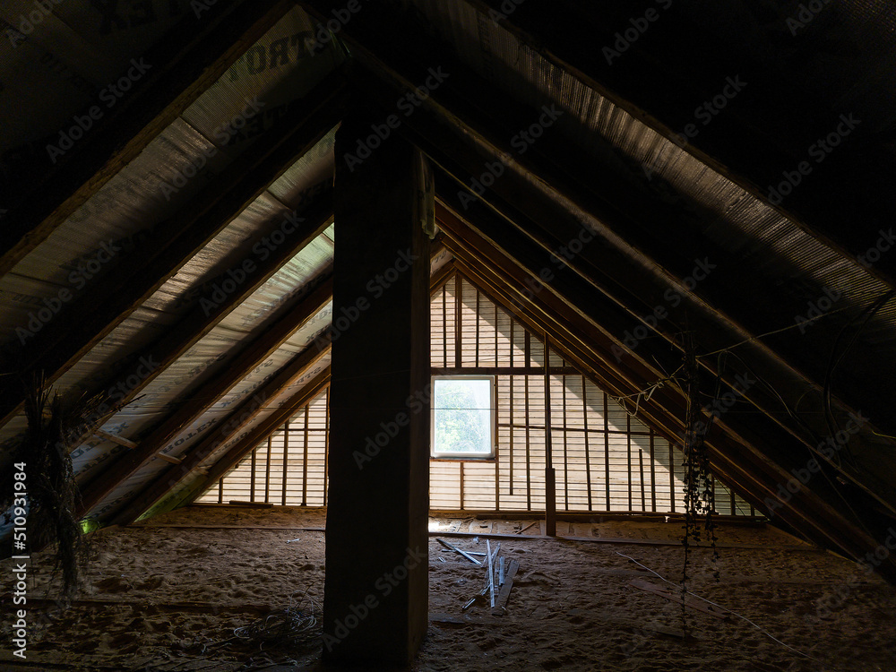 Zlekas, Latvia - Juny 4, 2022: Attic of an old house with a window.