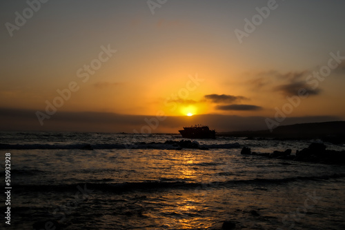 sunset on the sea with shipwreck 