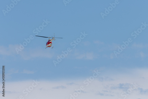 Helicopter Flying into a Blue Sky