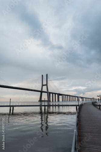 Beautiful long Vasa da Gama bridge with a pier. Lisbon, Portugal
