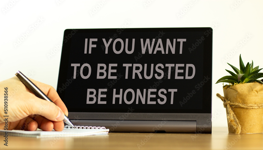 Be trusted and honest symbol. Concept words If you want to be trusted be honest on the black tablet. Businessman hand with pen. Business and be trusted and honest concept. Copy space. Be trusted and honest symbol. Concept words If you want to be trusted be honest on the black tablet. Businessman hand with pen. Business and be trusted and honest concept. Copy space.