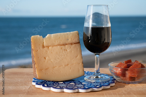 Tasting of sweet Spanish fortified Pedro Ximenez sherry wine with manchego cheese made with same sherry wine in El Puerto de Santa Maria, Andalusia, Spain photo