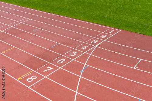 Staring grid numbers on a red athletics running track © Travers