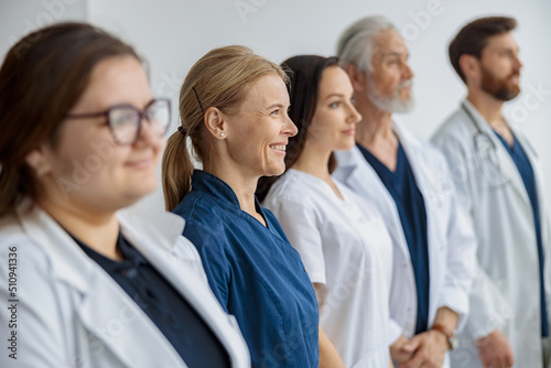 Group of professional doctors standing in a line at the modern clinic