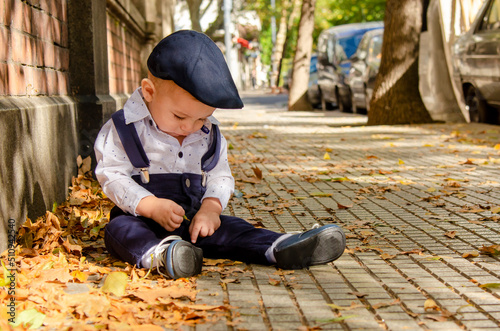 beautiful boy with blue hat in autumn landscape