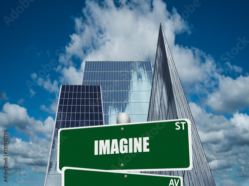 Street sign with the word Imagine on downtown financial district background.