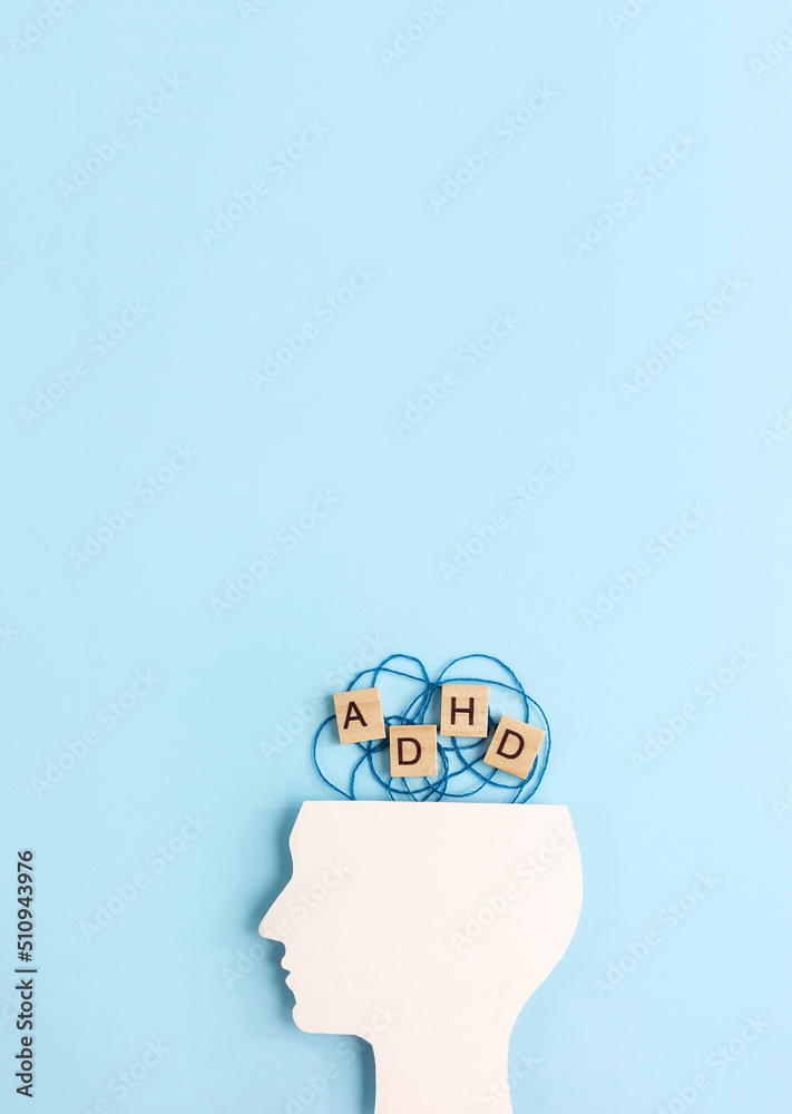Silhouette of human head and wooden blocks with the lettering ADHD on