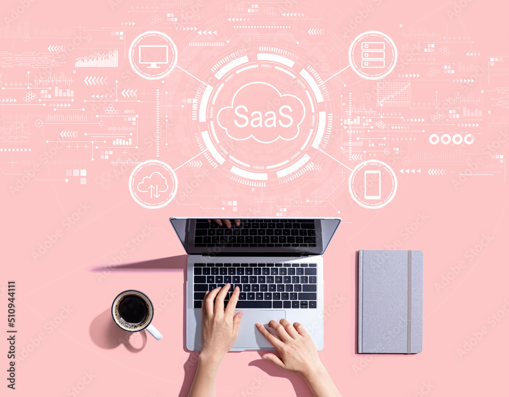 SaaS - software as a service concept with person using a laptop computer SaaS - software as a service concept with person using a laptop computer