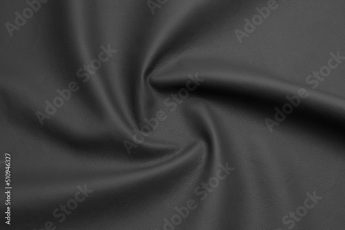 black artificial leather with waves and folds on PVC base