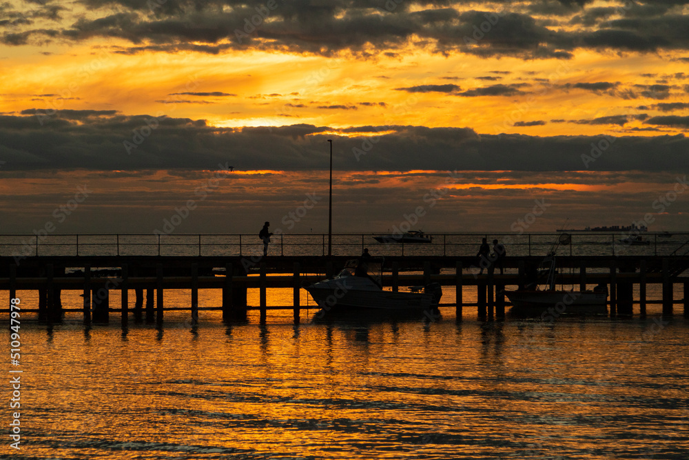 An sunset by the ocean with a jetty, in Melbourne Victoria.