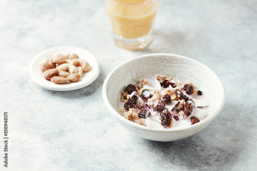 Bowl of granola with yogurt, nuts, cranberry and cocoanut. Concept for a tasty and healthy meal. Stone background. Bowl of granola with yogurt, nuts, cranberry and cocoanut. Concept for a tasty and healthy meal. Stone background.