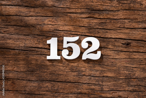 Number 152 - piece on rustic wood background