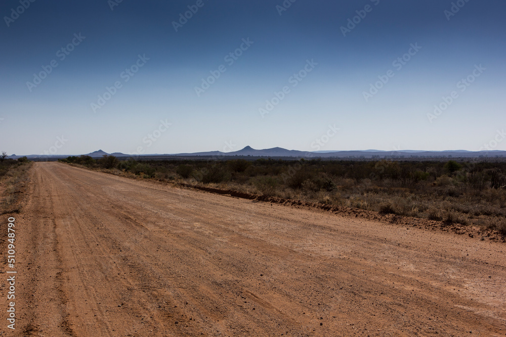 A dusty road leading into the distance in outback Australia A dusty road leading into the distance in outback Australia