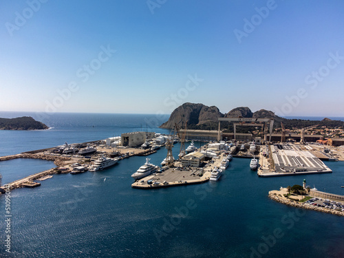 Panoramic aerial view on historical coastal Provencal city La Ciotat with large sailboat harbour and yacht shipyard, summer vacation in Provence, France
