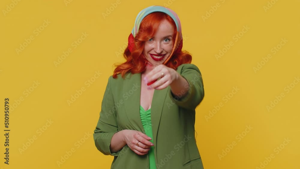 Hey you. Ginger woman in jacket smiling excitedly and pointing to camera, choosing lucky lottery winner, indicating to awesome you. Young redhead girl isolated alone on yellow studio wall background Hey you. Ginger woman in jacket smiling excitedly and pointing to camera, choosing lucky lottery winner, indicating to awesome you. Young redhead girl isolated alone on yellow studio wall background