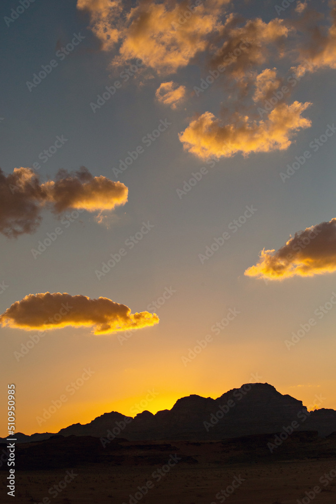 Sunset in Wadi Rum desert. Orange sunset sky and clouds in Wadi Rum, Jordan