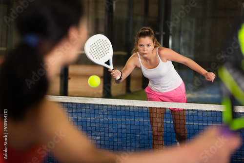 Woman playing padel tennis on the padel court