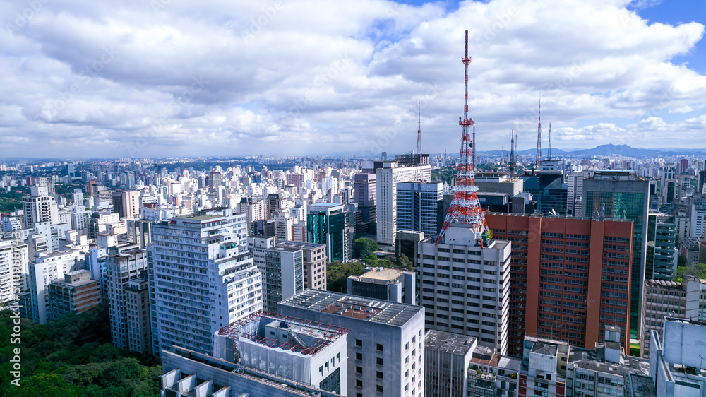 Fototapeta premium Aerial view of Av. Paulista in São Paulo, SP. Main avenue of the capital. With many radio antennas, commercial and residential buildings. Aerial view of the great city of São Paulo.
