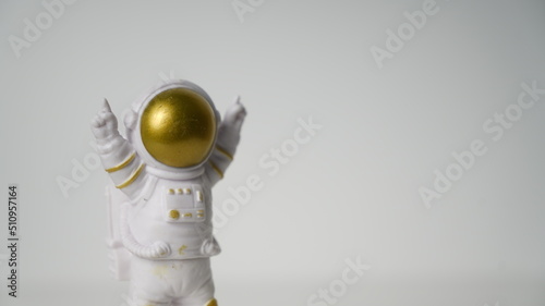 Astronaut figure raising finger at the moon, background, game, 3d 